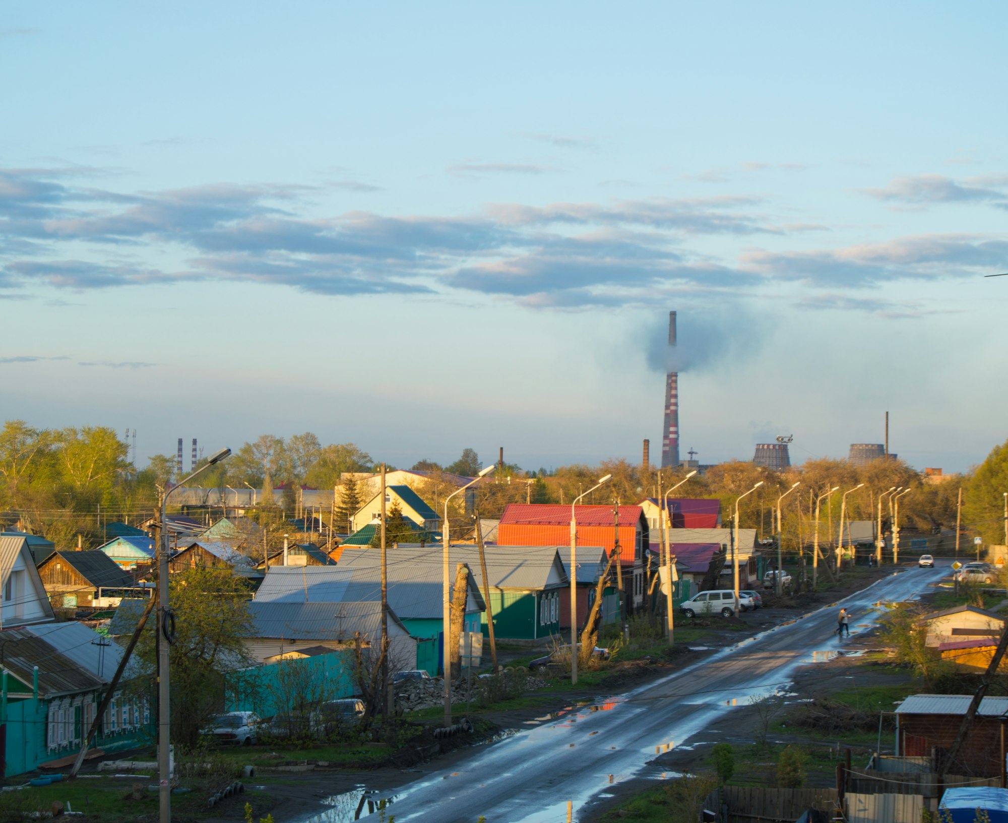 Smoke from the chimneys of boiler house in city near houses, problems of ecology